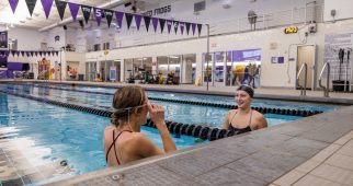 Students swim in the indoor pool at the Campus Recreation Center. Photo by James Anger on February 6, 2024.