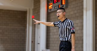 A student referees an intramural basketball game inside the Campus Recreation Center. Photo by James Anger on February 6, 2024.
